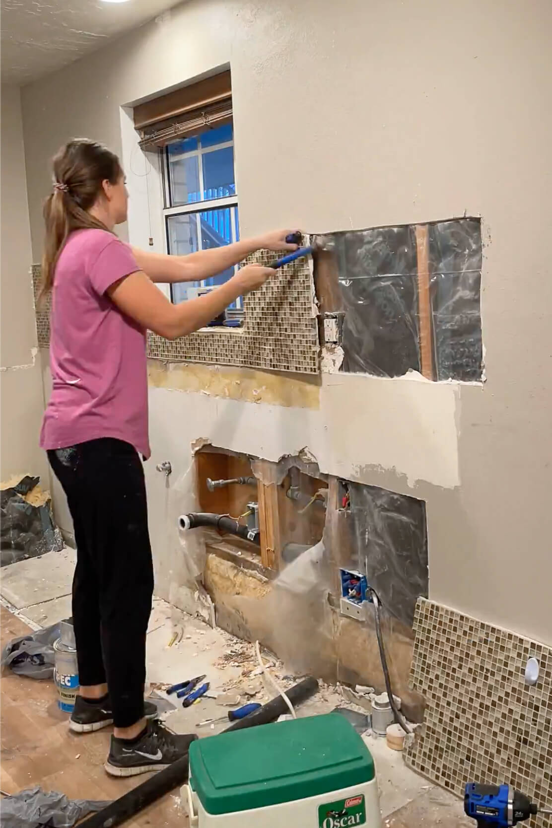 Removing a mosaic tile backsplash.